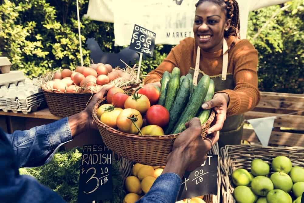 Woman selling produce at farmers market